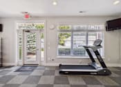 Thumbnail 20 of 26 - A treadmill is in a room with a window and a clock on the wall.