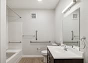 Thumbnail 18 of 36 - A white bathroom with a toilet, sink, and shower.