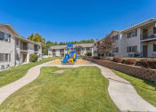 Thumbnail 15 of 18 - the preserve at ballantyne commons walkway with playground and apartment buildings