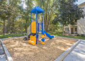 Thumbnail 12 of 18 - A playground with a blue and yellow structure.