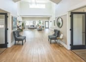 Thumbnail 3 of 18 - a large living room with a hard wood floor and doors