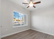 Thumbnail 6 of 36 - A room with a ceiling fan and a window with blinds.