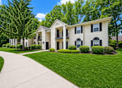 Thumbnail 4 of 21 - Apartment building exterior with manicured lawn at Northview Park Apartments, Sterling Heights, 48310