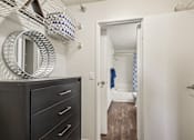 Thumbnail 19 of 24 - A bathroom with a wooden floor and a white door.