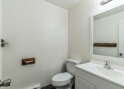 Thumbnail 18 of 32 - a bathroom with a sink toilet and a mirror