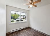 Thumbnail 17 of 32 - the living room of an apartment with a large window and a ceiling fan