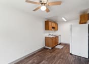 Thumbnail 2 of 32 - an empty kitchen with a refrigerator and a ceiling fan