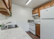 Thumbnail 3 of 32 - a kitchen with white appliances and wood cabinets