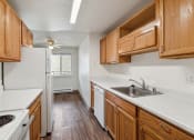 Thumbnail 4 of 32 - a kitchen with wooden cabinets and white appliances and a sink