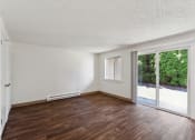Thumbnail 6 of 32 - an empty living room with wood floors and a sliding glass door