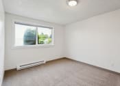 Thumbnail 12 of 32 - an empty room with a window and carpet