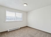 Thumbnail 13 of 32 - the living room of an apartment with carpet and a window