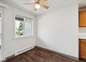 Thumbnail 7 of 32 - an empty living room with a ceiling fan and a window