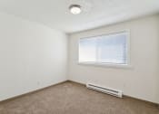Thumbnail 10 of 32 - the living room of an apartment with carpet and a window