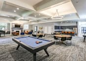 Thumbnail 11 of 26 - Resident clubhouse with pool table and seating at The Beckstead Apartments, South Jordan, 84095