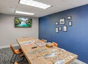 Thumbnail 6 of 26 - Community puzzle room with activity table at The Beckstead Apartments, South Jordan, Utah