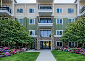 Thumbnail 2 of 26 - Modern apartment building exterior with landscaped courtyard at The Beckstead Apartments, Utah
