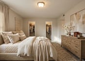 Thumbnail 20 of 22 - A bedroom with a large bed and a dresser.