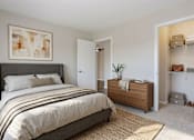 Thumbnail 13 of 13 - A bedroom with a large bed and a wooden cabinet at Arbors at Hickory Creek Apartments , Apartments, University Park, IL