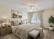 Thumbnail 21 of 23 - A bedroom with a bed, nightstands, and a ceiling fan.