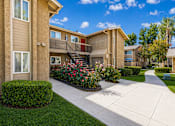 Thumbnail 2 of 21 - A sunny day at apartment complex with a clear blue sky.