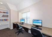 Thumbnail 15 of 22 - A room with a desk, two chairs, and a bookshelf.