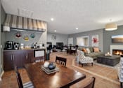 Thumbnail 4 of 14 - Community clubhouse with coffee bar and lounge seating at Carver Ridge Townhomes Apartments, Chaska, MN
