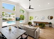 Thumbnail 11 of 22 - A modern living room with a pool view.