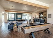Thumbnail 7 of 13 - A billiard table is in the middle of a modern living room.