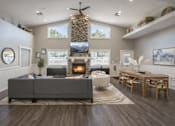 Thumbnail 3 of 10 - A modern living room with a grey sofa and a fireplace.