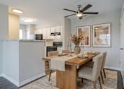 Thumbnail 9 of 13 - A dining room with a wooden table and chairs at Arbors at Hickory Creek Apartments , Illinois, 60484