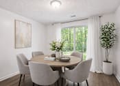 Thumbnail 11 of 15 - A dining room with a table set for four and a view of the backyard.