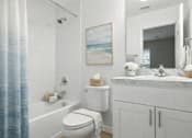 Thumbnail 17 of 17 - A bathroom with a white toilet, a white sink, and a blue shower curtain.