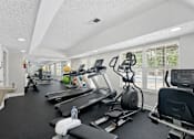 Thumbnail 11 of 22 - A well-equipped gym with treadmills, exercise bikes, and other fitness equipment.