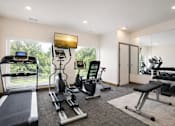 Thumbnail 3 of 13 - Fitness center with cardio and strength equipment at Lake Ridge Apartments, Minnesota