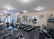 Thumbnail 1 of 8 - Fitness center with cardio and strength equipment at The Ponds at Heritage Place Apartments, Sartell, 56377