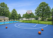 Thumbnail 6 of 13 - A basketball court with a blue surface and three basketballs on it.