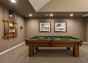 Thumbnail 4 of 7 - A pool table with two pool cues and two pool balls on it.