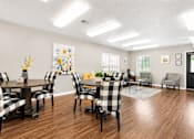 Thumbnail 3 of 20 - A dining room with a table set for six people.