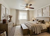 Thumbnail 18 of 22 - A bedroom with a large bed and a ceiling fan.