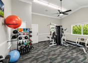 Thumbnail 9 of 22 - A well-equipped home gym with a variety of exercise equipment.