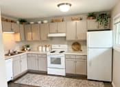 Thumbnail 14 of 14 - A kitchen with white appliances and cabinets.