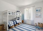 Thumbnail 13 of 16 - A room with two bunk beds and a striped rug.