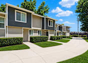 Thumbnail 2 of 16 - A row of modern houses with grey and beige siding.