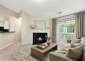 Thumbnail 16 of 26 - Living room with fireplace and sliding glass doors at Delta Crossing Apartments, Charlotte, North Carolina