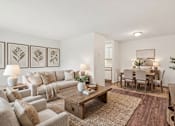 Thumbnail 7 of 14 - Living room and dining area with neutral decor at Carver Ridge Townhomes Apartments, Chaska, MN