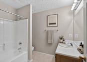 Thumbnail 14 of 14 - A bathroom with a white tub and sink.