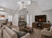 Thumbnail 3 of 14 - A cozy living room with a fireplace and comfortable seating.
