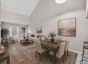 Thumbnail 5 of 14 - A dining room with a wooden table and chairs.