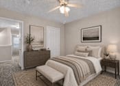 Thumbnail 10 of 14 - A bedroom with a bed, nightstand, and a ceiling fan.
